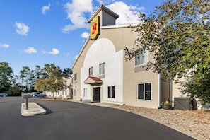 A hotel with a prominent 'Super 8' sign, a modern architectural design, and a well-maintained driveway. - Super 8 by Wyndham Cloverdale IN (Cloverdale)