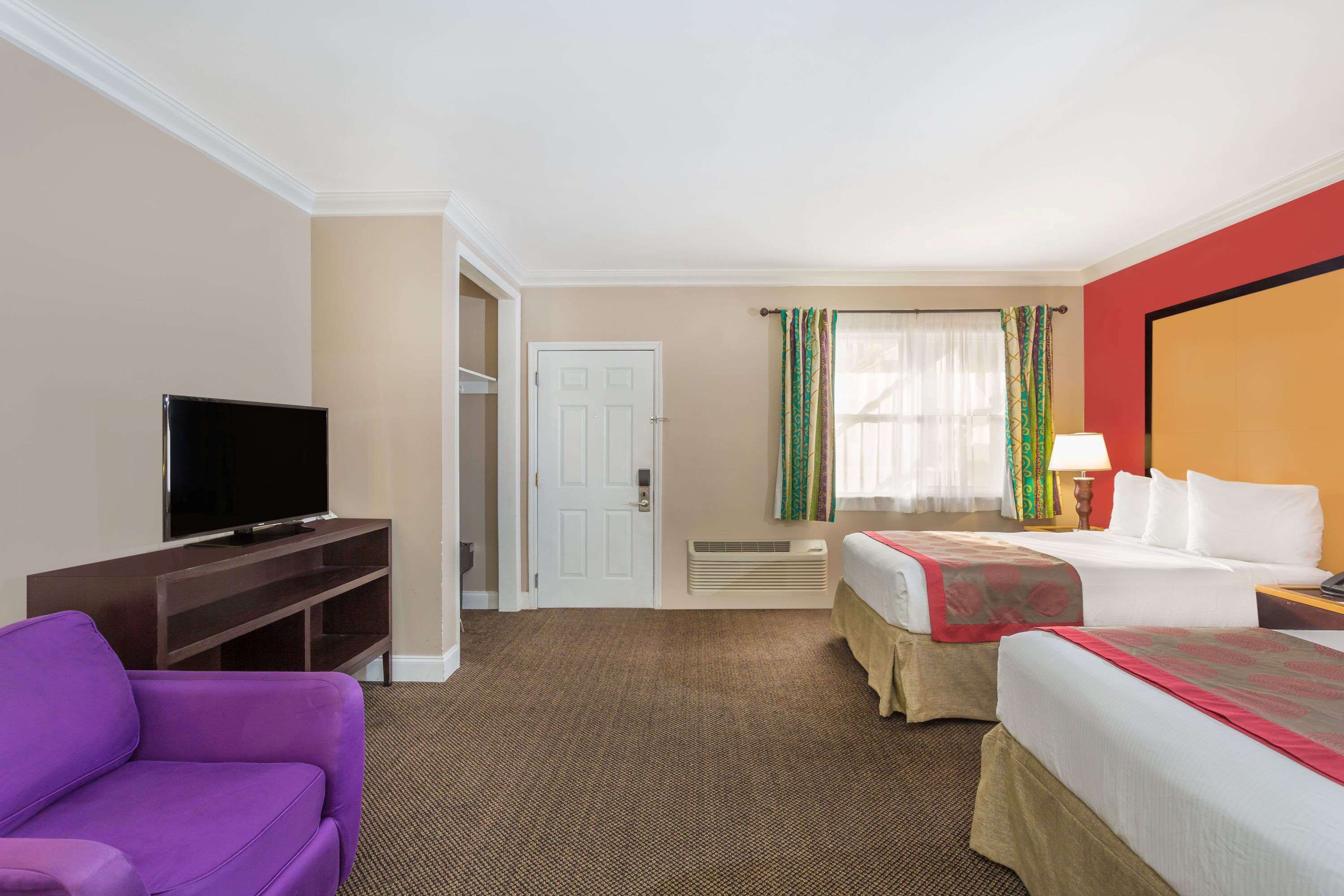 deluxe room, multiple beds, non smoking, pool view | in-room safe, blackout curtains, soundproofing, iron/ironing board