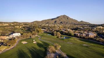 Enjoy a round of golf amidst well-maintained fairways, sand bunkers, and lush trees.