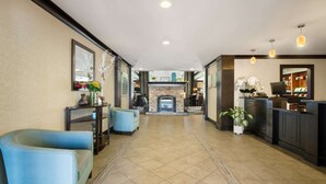 A spacious lobby with a fireplace, seating area, and a reception desk. - Sonesta ES Suites San Diego - Rancho Bernardo (San Diego)
