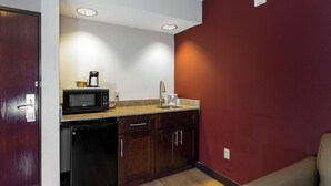 A compact kitchenette with a microwave, coffee maker, and sink. - Red Roof Inn & Suites Dover Downtown (Dover)