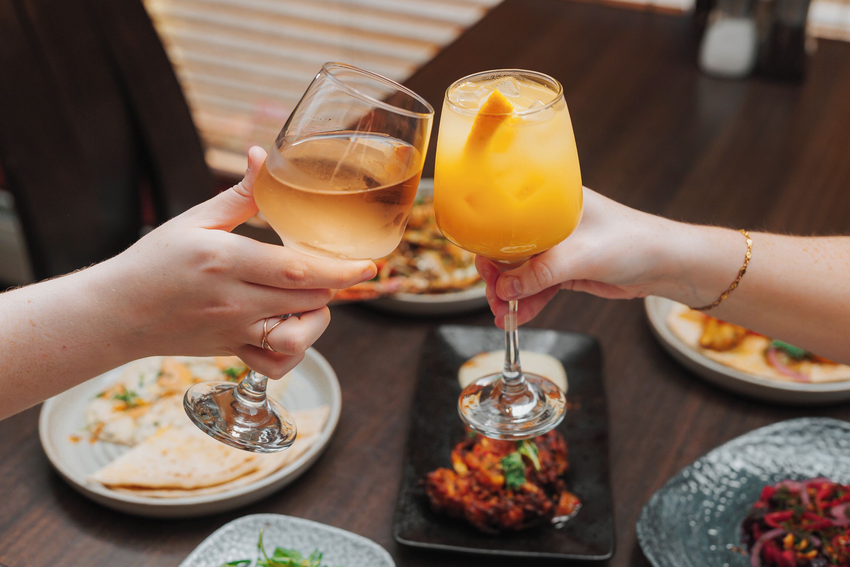 Two people toasting with wine glasses.