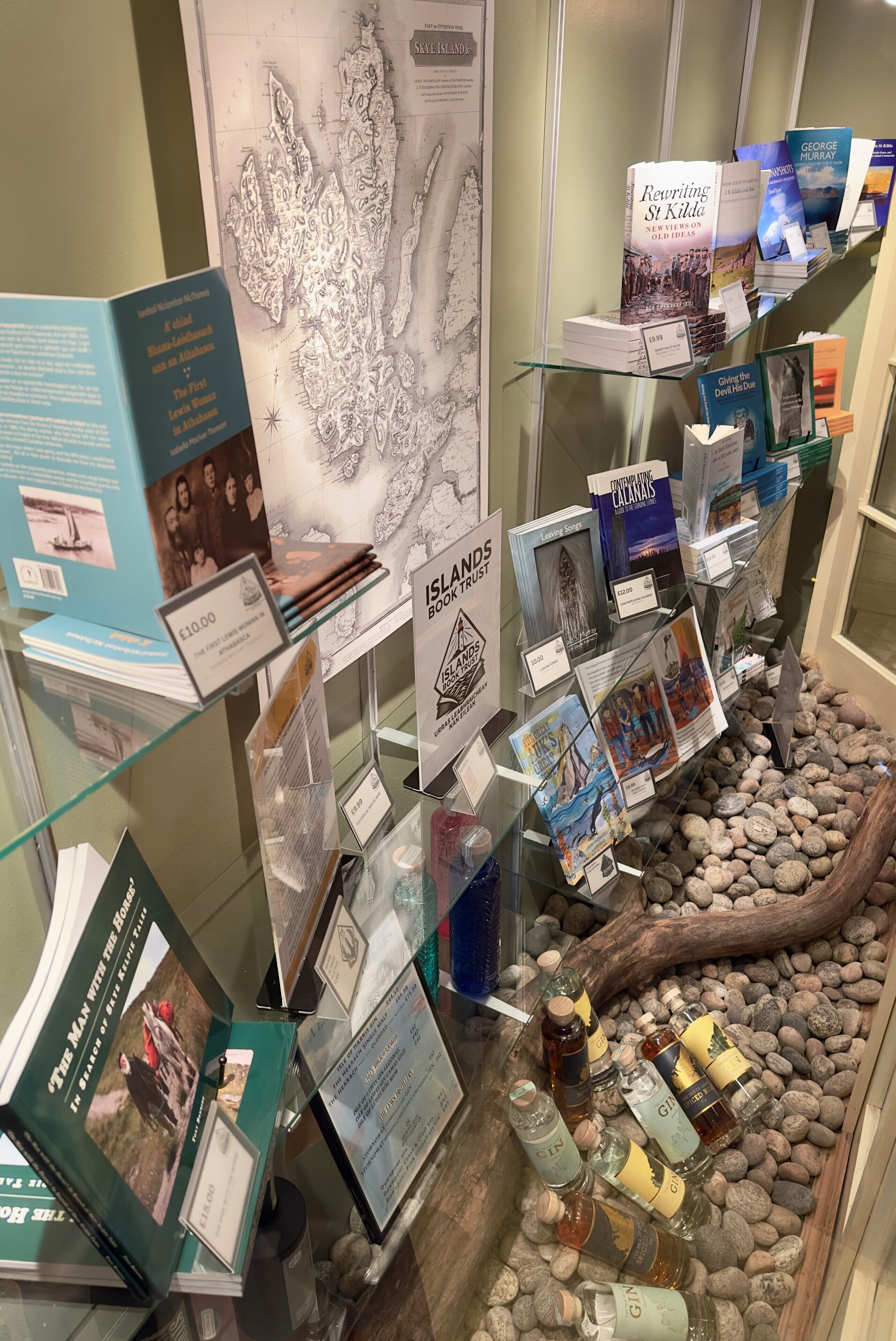 A bookstore display with books, price tags, and a map.