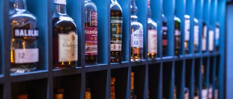 A row of liquor bottles on shelves.