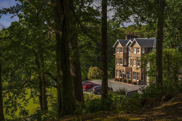 Experience tranquility in a serene, setting surrounded by lush greenery and mature trees.