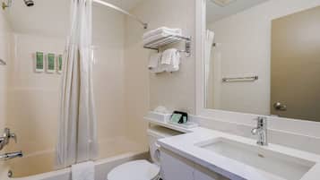 A modern bathroom with a bathtub, toilet, and sink.