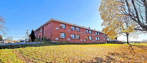 A red brick building with multiple windows and a flat roof.
