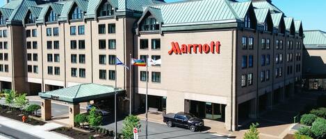 A Marriott hotel with a modern architectural design, featuring a prominent 'Marriott' sign on the facade.