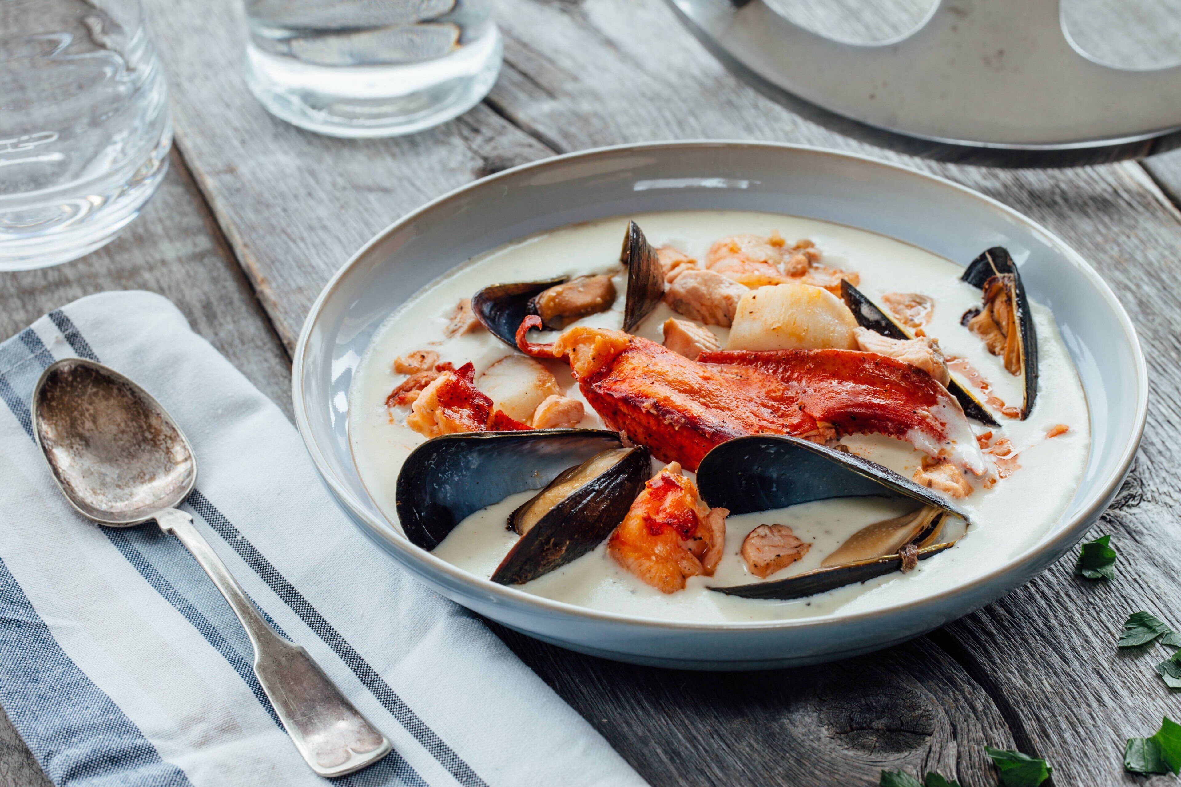 A seafood dish in a bowl on a wooden table.