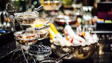 Una mesa de buffet con diferentes alimentos y cubiertos.