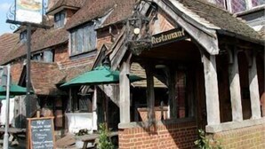 A traditional pub with a signboard, outdoor seating, and a chalkboard menu. - Chequers Inn Hotel (Forest Row)