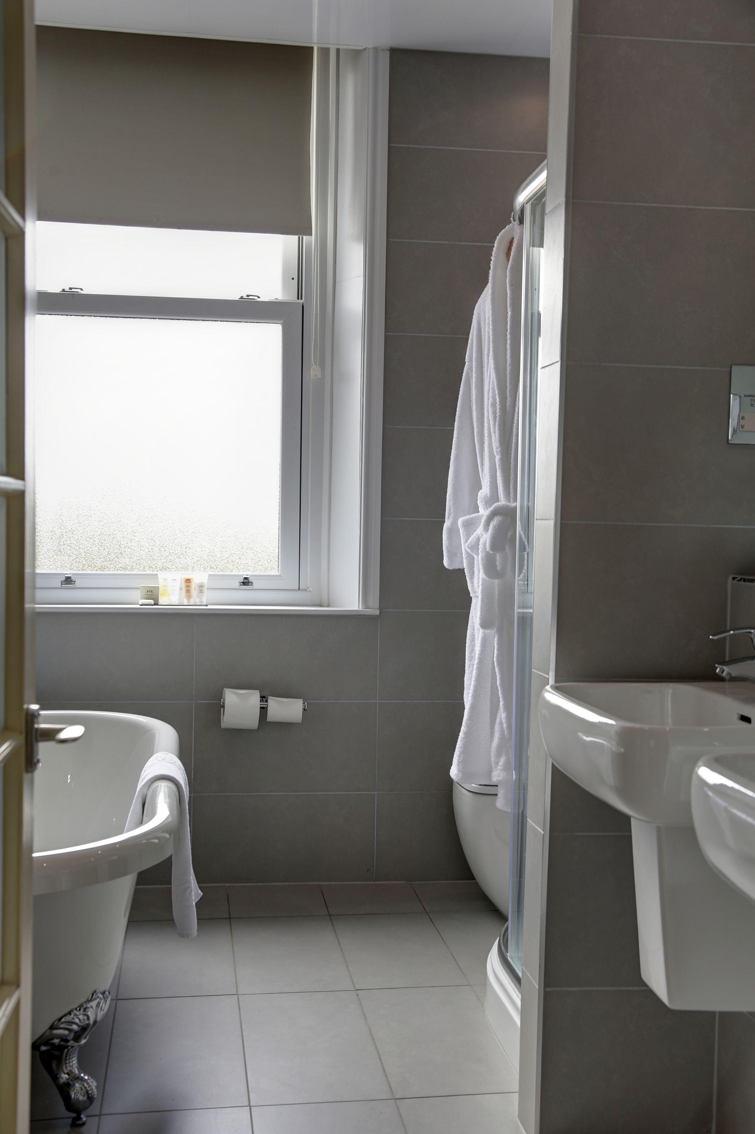 A modern bathroom with a bathtub, a shower, and a sink.
