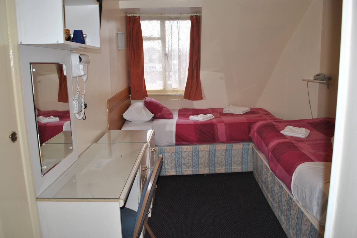 Twin Room | Desk, iron/ironing board (on request), WiFi (surcharge), bed sheets