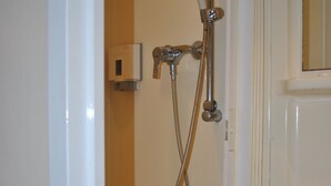 A bathroom with a shower, a sink, and a mirror. - Grenville Hotel (London)