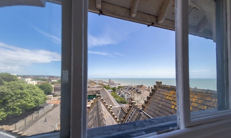 A coastal cityscape viewed from a high vantage point, including buildings, a sea view, and a clear sky.. The Highlands Inn