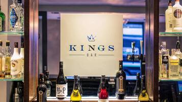 A bar area with a sign reading 'KINGS BAR' and various bottles of alcohol.