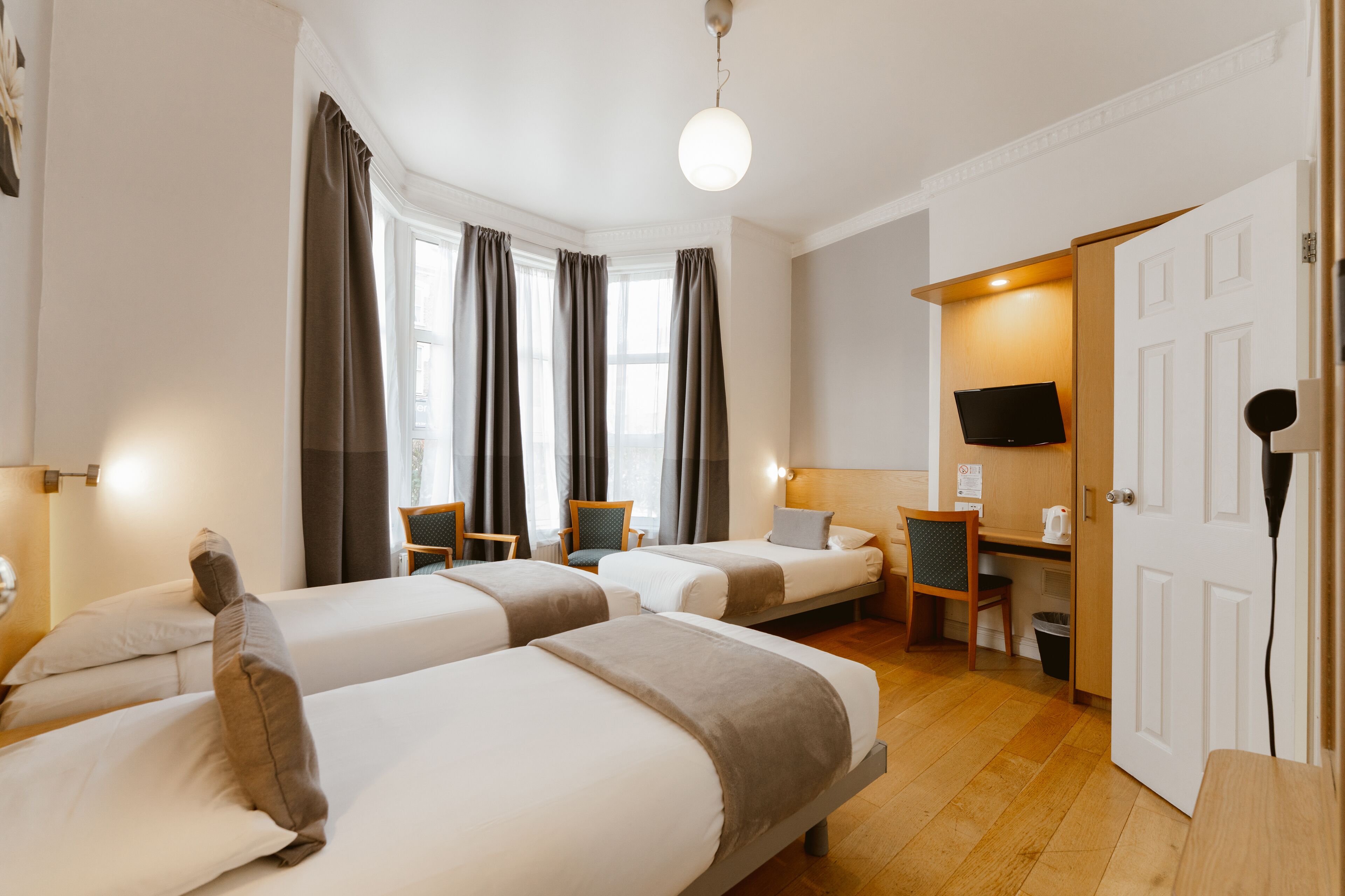 Triple Room | Desk, blackout drapes, free cribs/infant beds, free WiFi