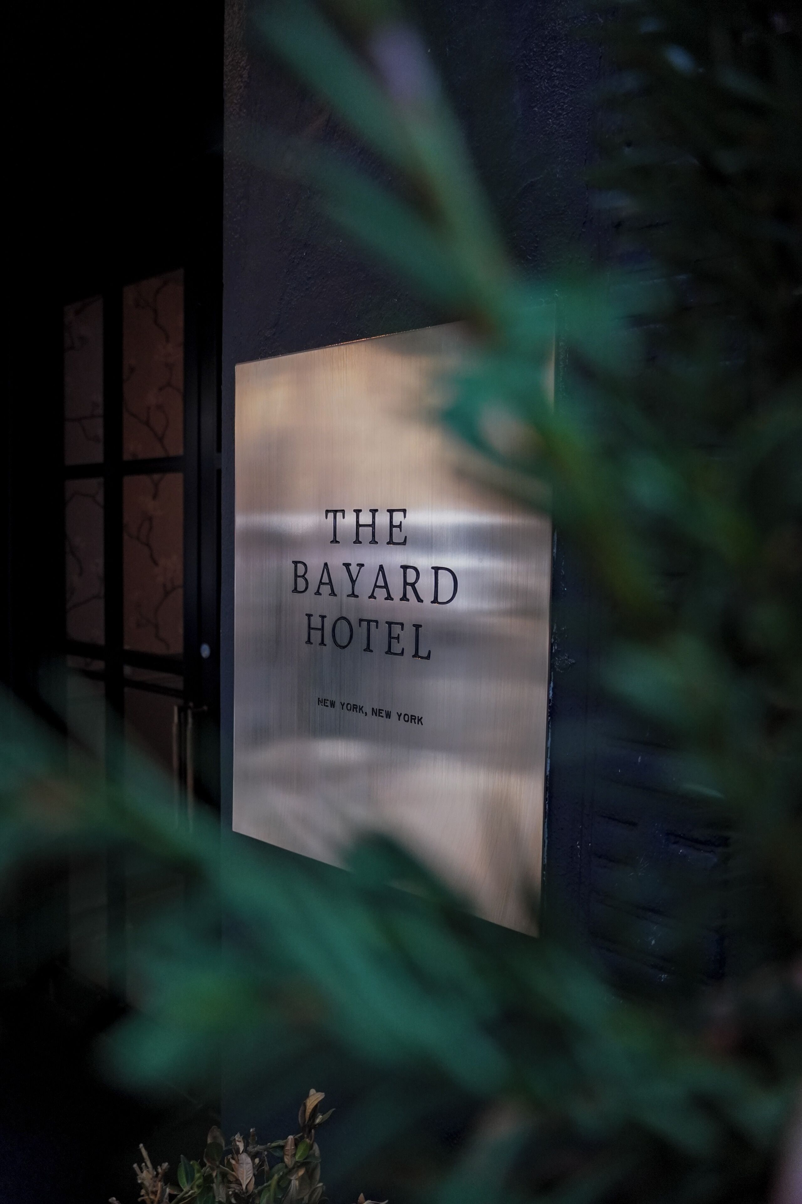 A sign for The Bayard Hotel with a clear view of the hotel's name and location.