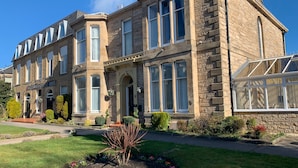 A historic building with a stone facade, large windows, and a conservatory. - Northumberland Hotel (Edinburgh)