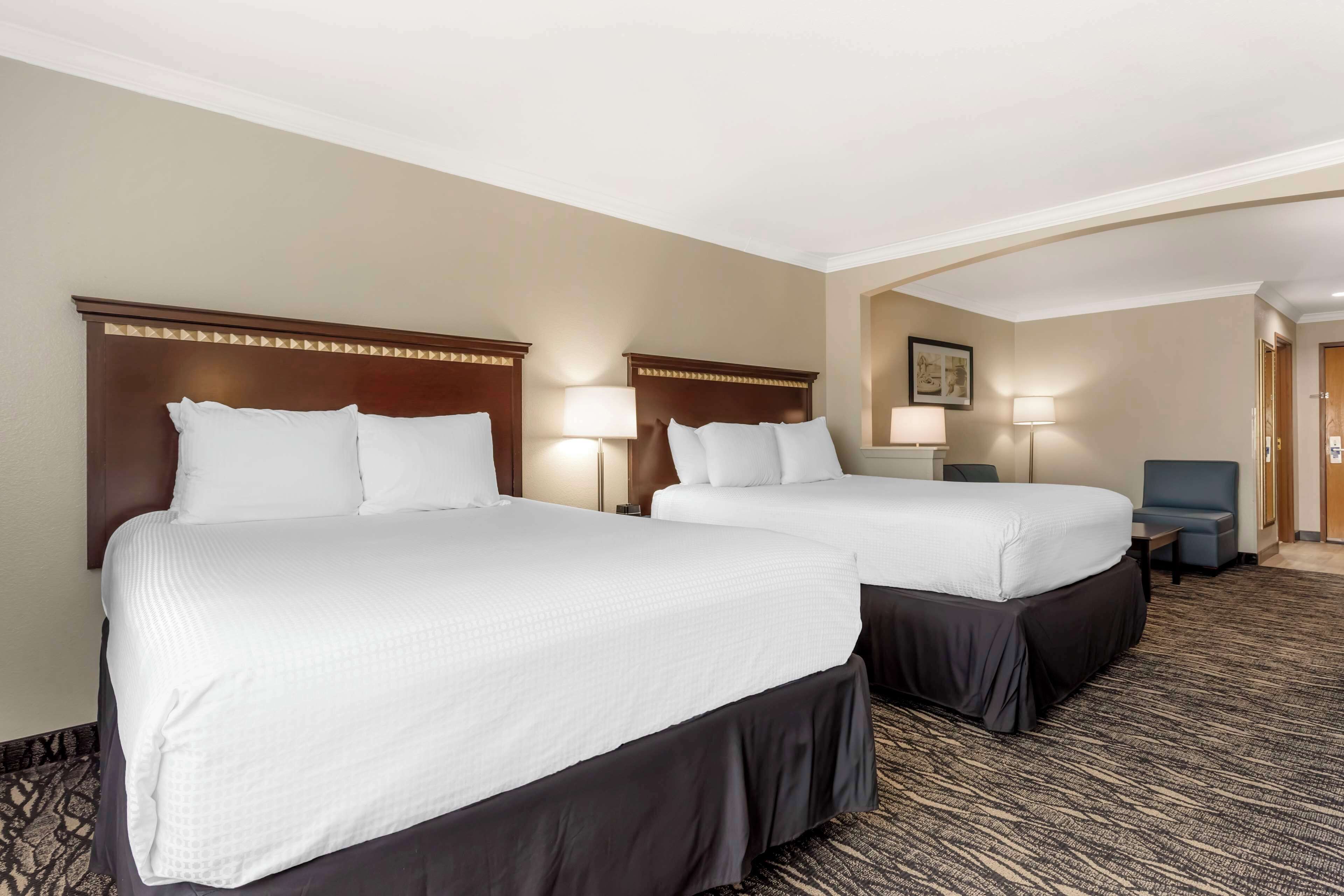 pillow-top beds, desk, laptop workspace, blackout curtains