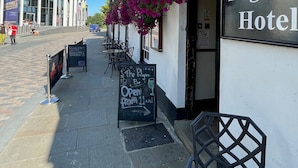 A building with a sign reading "Pilgrim Hotel" and a hanging flower basket. - Pilgrims Hotel (Canterbury)