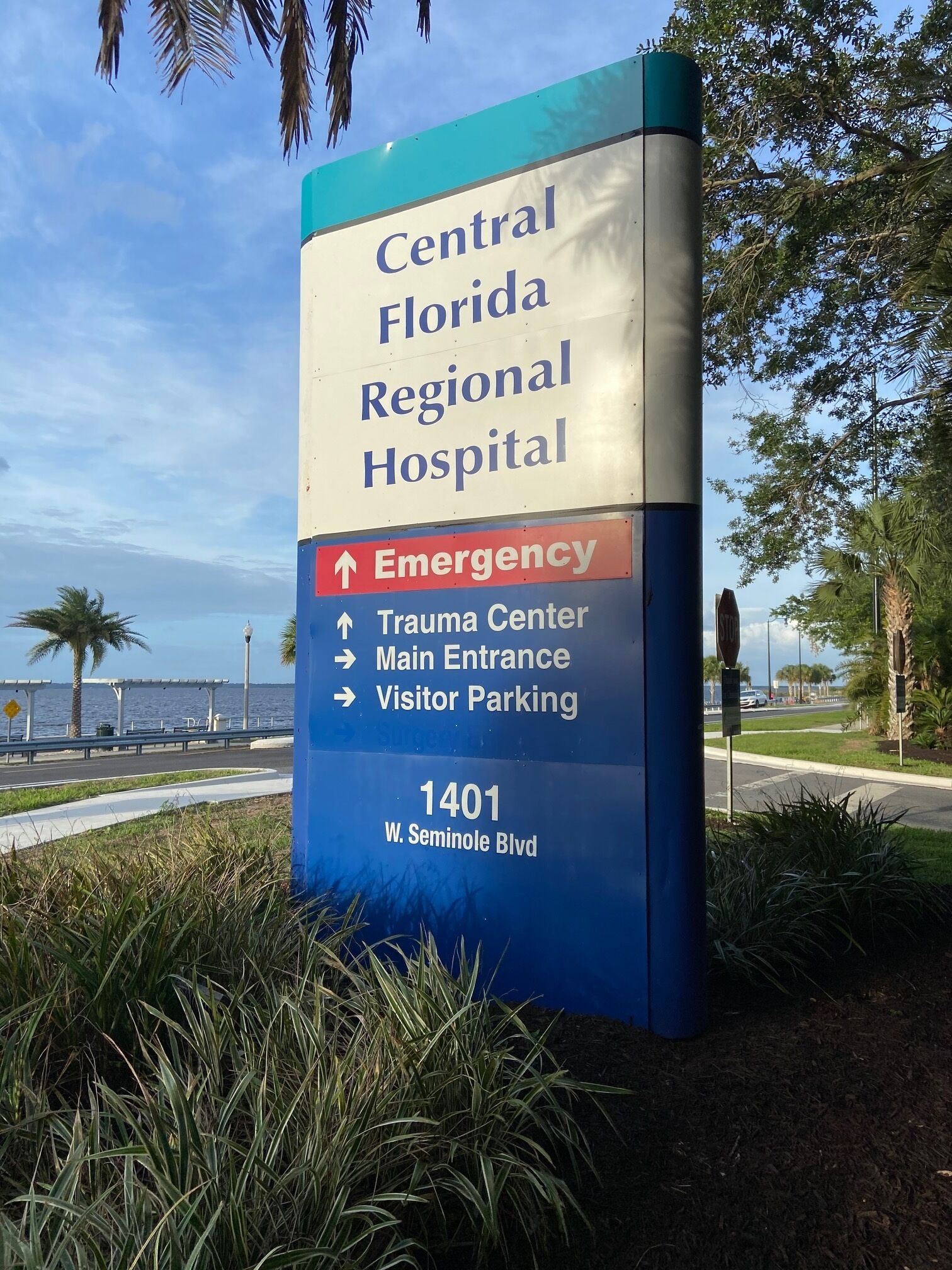 A sign for Central Florida Regional Hospital with directions to the Emergency, Trauma Center, Main Entrance, and Visitor Parking.