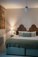Ein Schlafzimmer mit einem Bett, einem Nachttisch, einer Lampe und einer Deckenleuchte.