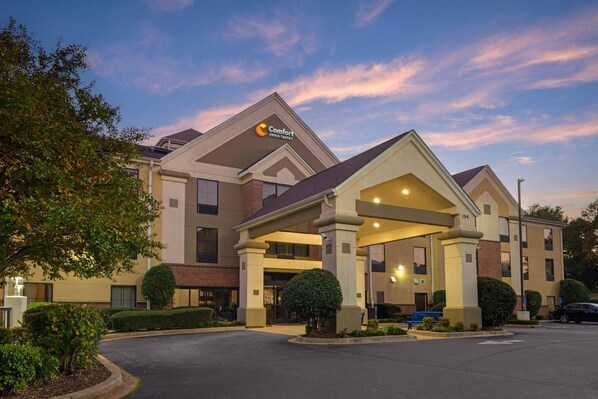 A Comfort Inn with a modern architectural design, featuring a prominent entrance and a well-maintained outdoor area with landscaping. - Comfort Inn & Suites Spartanburg North (Spartanburg)