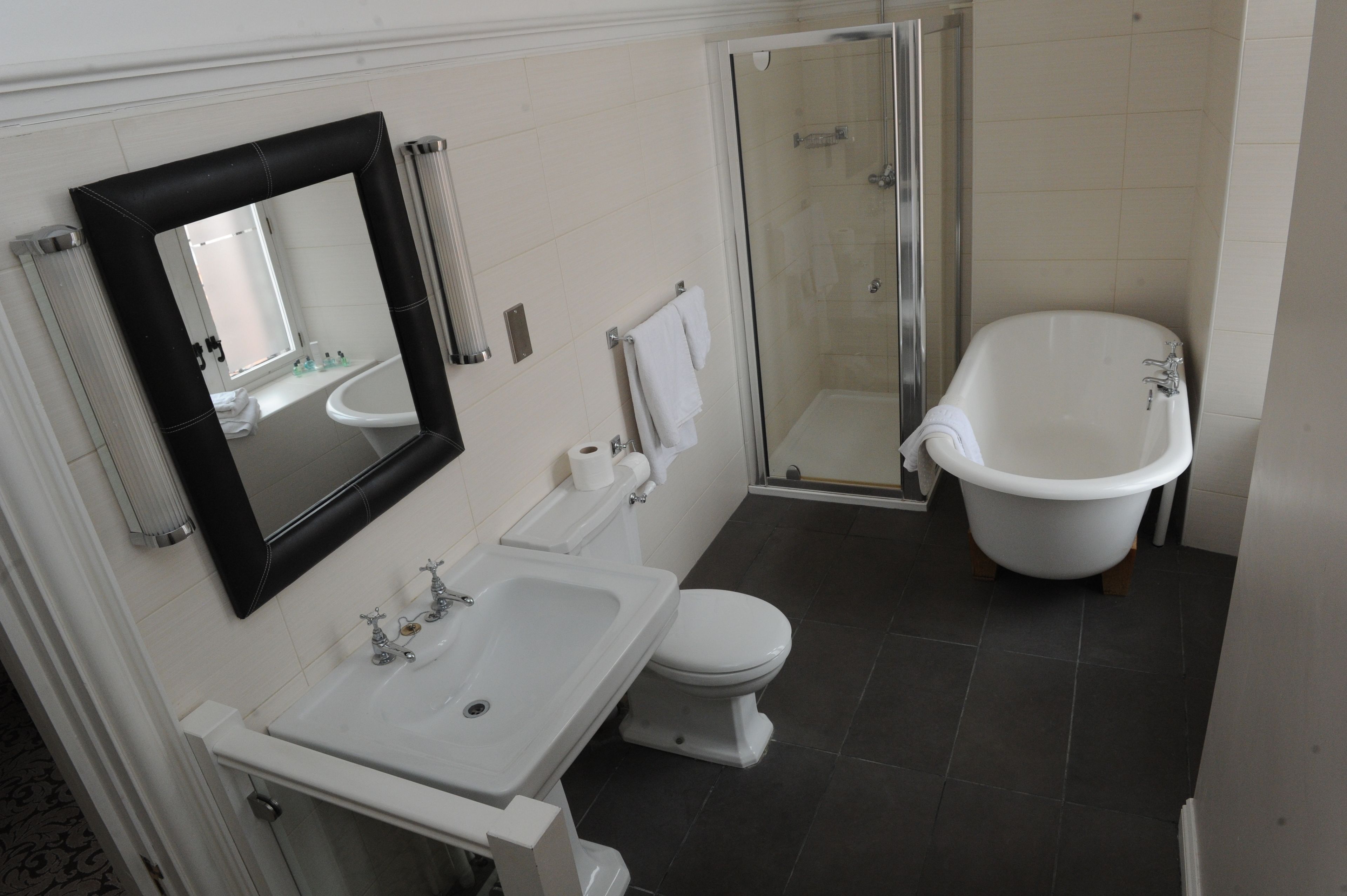 A bathroom with a white sink, toilet, and bathtub.