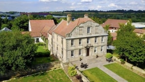 A large stone building with a symmetrical facade, multiple windows, and a central entrance. - Hellaby Hall Hotel, BW Signature Collection (Rotherham)