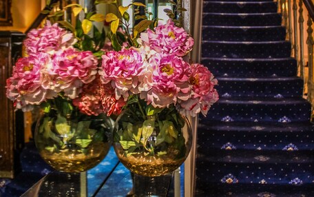A staircase with a dark blue carpet and a handrail.
