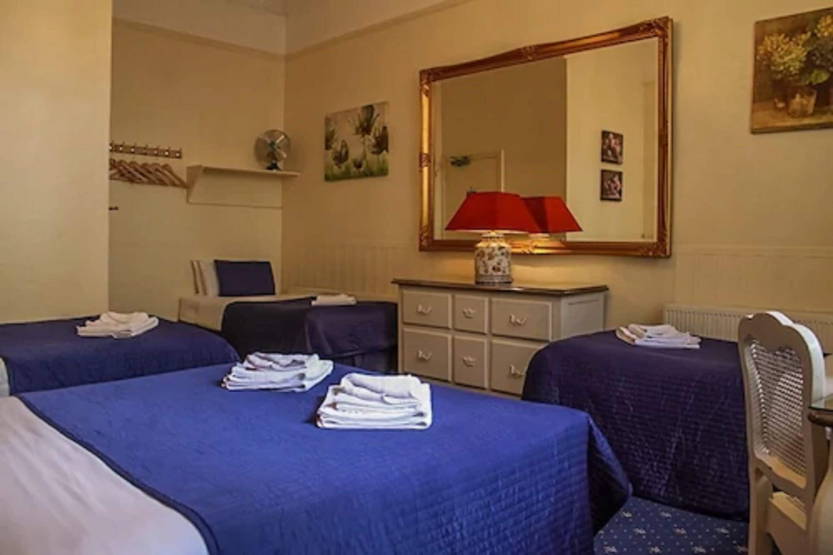 family room (private bathroom adjacent) | desk, laptop workspace, blackout curtains, iron/ironing board