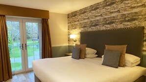 A large bed with a headboard, a nightstand, and a lamp. - Balmacara Hotel (Kyle)