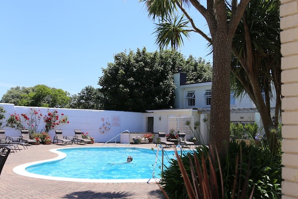 Outdoor pool, open 9 AM to 7 PM, pool loungers