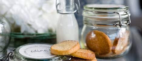 A glass jar with a metal clasp lid, a glass bottle with a metal cap, and a glass container with a metal clasp lid.
