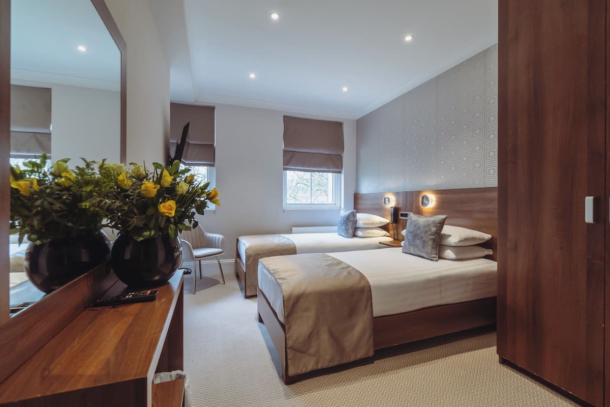 Twin Room, Garden View | Minibar, in-room safe, iron/ironing board, free WiFi