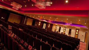 A conference room with rows of chairs, a large chandelier, and a red ceiling. - Hull Humber View Hotel, Sure Hotel Collection by BW (North Ferriby)