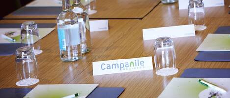 A conference table with nameplates, water bottles, and name tags.