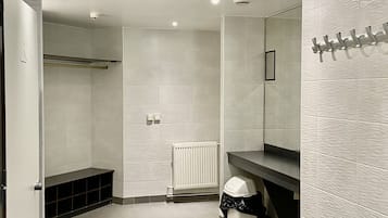 Une salle de bain moderne avec une douche à l’italienne, des toilettes, un lavabo et un miroir.