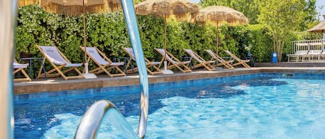 Seasonal outdoor pool, open 9:00 AM to 9:00 PM, pool umbrellas