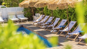 Seasonal outdoor pool, open 9:00 AM to 9:00 PM, pool umbrellas
