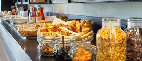 A buffet with various food items and condiments.