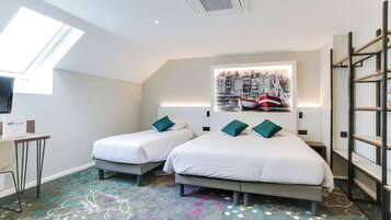 A hotel room with two beds, a desk, a chair, a TV, a skylight, and a cityscape painting.