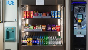 A vending machine with a variety of snacks and beverages, including Pringles, Cadbury Dairy Milk, and Pepsi. - Holiday Inn Express London Luton Airport by IHG (Luton)