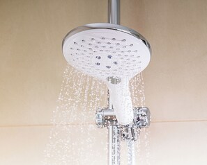 A showerhead with water flowing from it.