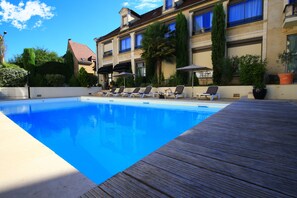 Seasonal outdoor pool, open 9:00 AM to 8:30 PM, pool loungers