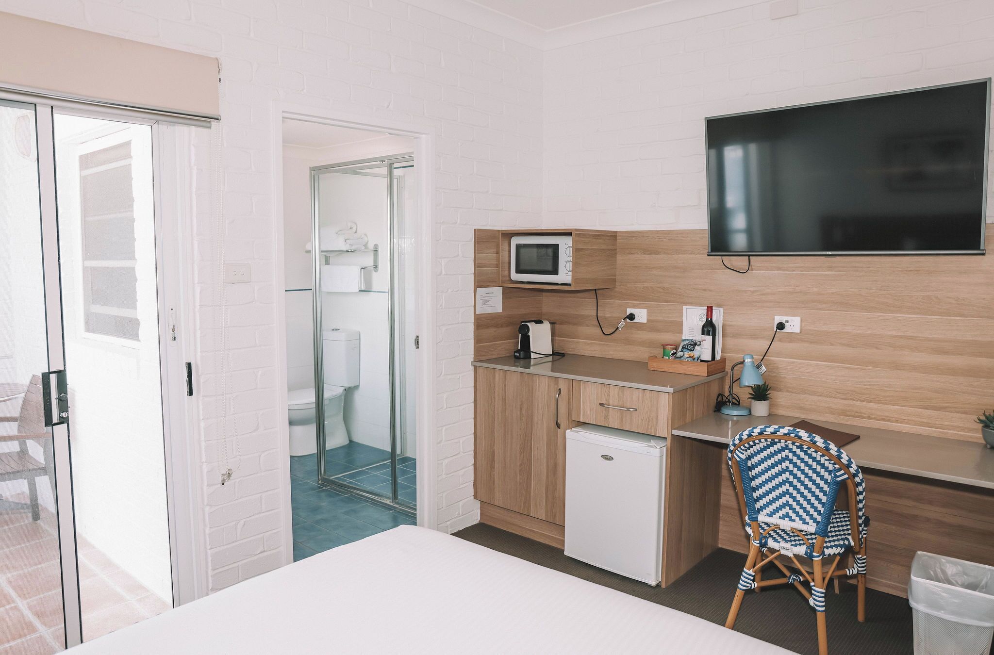 A compact kitchenette with a microwave, coffee maker, and small refrigerator.
