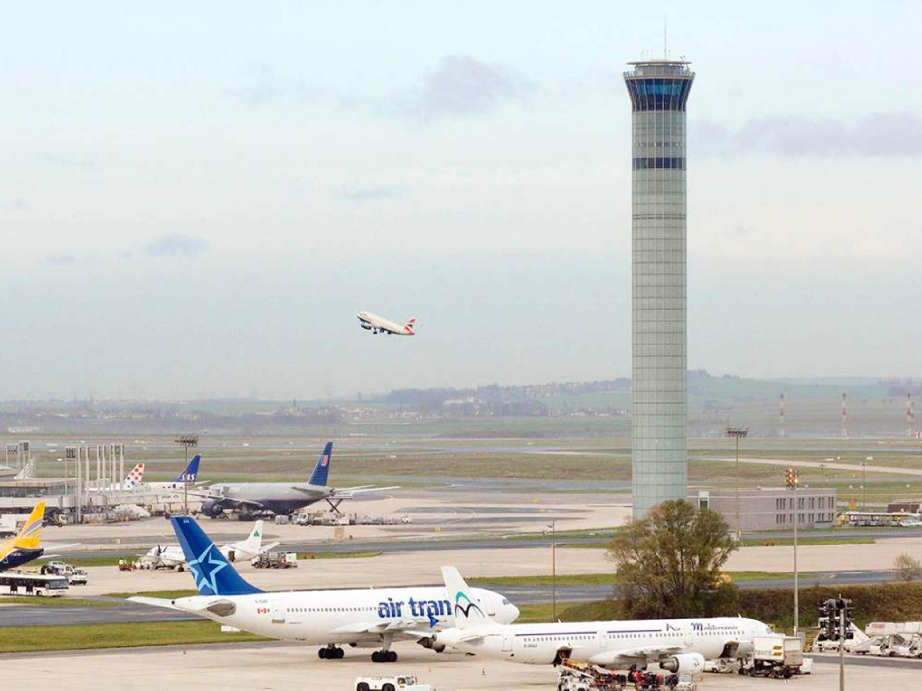An airport with multiple airplanes, including Air Transat, and a control tower.