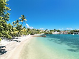 On the beach, white sand, sun loungers, beach towels