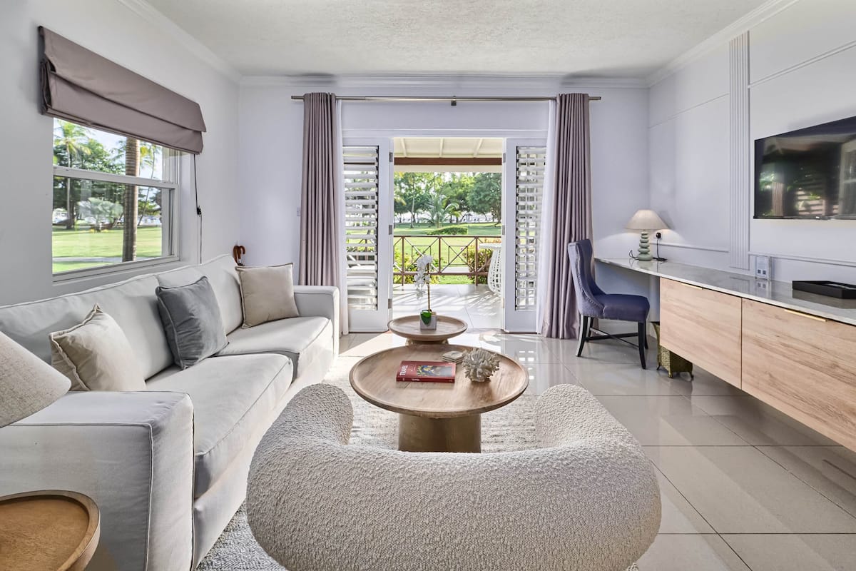 A modern living room with a sofa, coffee table, and TV.